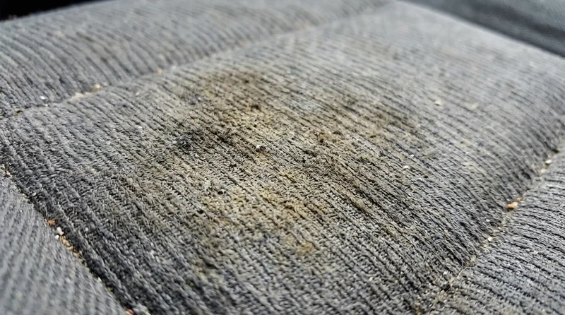 Car interior with fabric seats showing smoke residue
